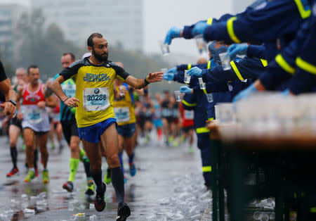 Athletics - Berlin Marathon - Berlin, Germany - September 24, 2017 Runners are given water during the race REUTERS/Hannibal Hanschke