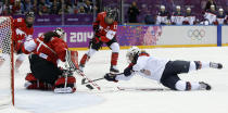 Jocelyne Lamoureux of the United States (17) tries to score against goalkeeper Shannon Szabados of Canada (1) during the second period of the women's gold medal ice hockey game at the 2014 Winter Olympics, Thursday, Feb. 20, 2014, in Sochi, Russia. (AP Photo/Matt Slocum)