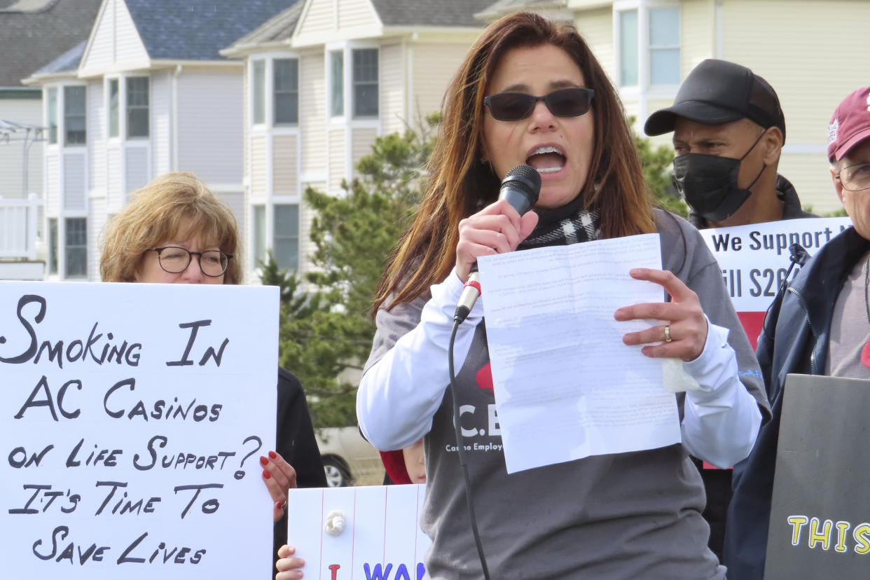 Nicole Vitola, a dealer at the Borgata casino, speaks at a rally in Atlantic City, N.J. on April 12, 2022, calling on state lawmakers to ban smoking in the gambling halls. (AP Photo/Wayne Parry)