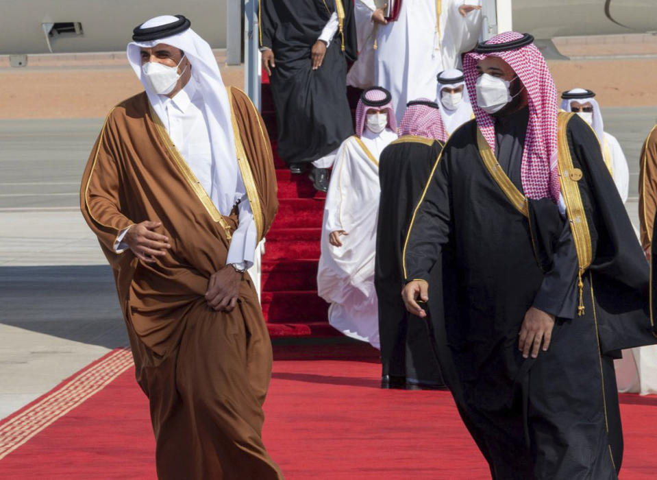 FILE - In this Jan. 5, 2021, file photo, provided by the Saudi Royal Court, Saudi Arabia's Crown Prince Mohammed bin Salman, right, welcomes Qatar's Emir Sheikh Tamim bin Hamad al-Thani upon his arrival to attend the Gulf Cooperation Council's 41st Summit in Al-Ula, Saudi Arabia. Qataris awoke to a surprise blockade and boycott by Gulf Arab neighbors 3 1/2 years ago, and this week were jolted again by the sudden announcement that it was all over. (Saudi Royal Court via AP, File)