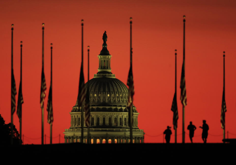 <p>The U.S. Capitol dome backdrops flags at half-staff in honor of the victims killed in the Las Vegas shooting as the sun rises on Tuesday, Oct. 3, 2017, at the foot of the Washington Monument on the National Mall in Washington. (Photo: Manuel Balce Ceneta/AP) </p>