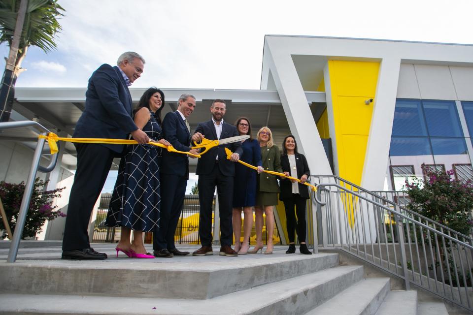 From left, Discover the Palm Beaches Chief Marketing Officer Milton Segarra, Boca Raton City Council Member Yvette Drucker, Boca Raton Mayor Scott Singer, Brightline President Patrick Goddard, Florida State Senator Tina Scott Polsky, and Boca City Council Members Monica Mayotte and Andrea Levine O'Rourke stand on the stairs of the new Boca Raton Brightline station and cut a ribbon on Tuesday, December 20, 2022, in Boca Raton, FL. Just one day short of a year since construction began at the site in Boca Raton, city and Brightline officials hosted a ribbon cutting ceremony ahead of the station opening to the public on December 21st.
