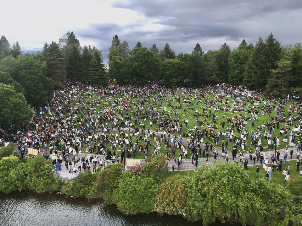 People gather in the Lilac Bowl at Riverfront Park in Spokane, Wash., Sunday, June 7, 2020, for a Black Lives Matter rally, sparked by the death of George Floyd, who died May 25 after being restrained by police in Minneapolis. (Jesse Tinsley/The Spokesman-Review via AP)