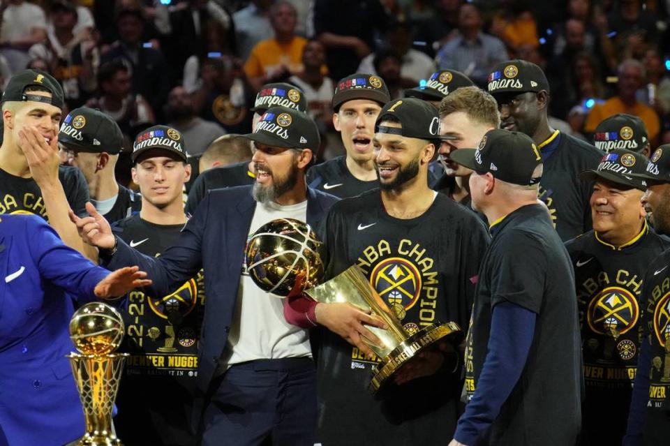 Nuggets guard Jamal Murray holds the Larry O’Brien Trophy after his team won the 2023 NBA Finals against the Heat on June 12, 2023.