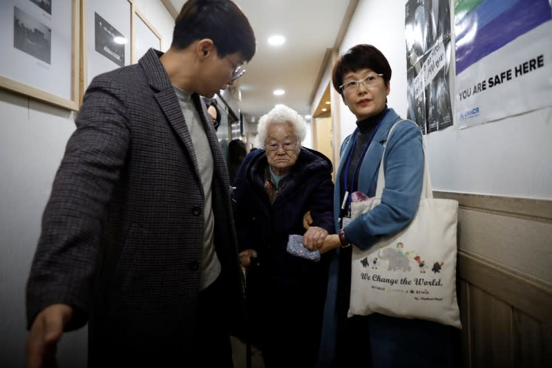 Former South Korean "comfort woman" Lee Ok-sun leaves after a news conference in Seoul