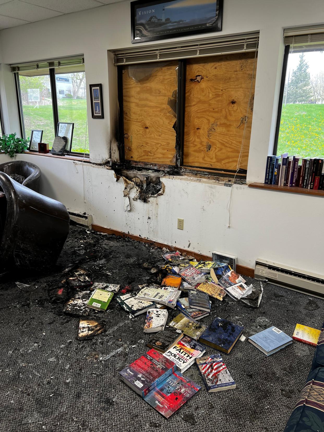 Damaged books are strewn across the office of Wisconsin Family Action Director Julaine Appling Sunday morning in Madison.