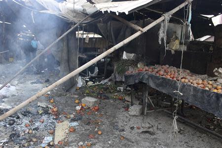 Scattered produce are pictured amid the rubble after what activists said was shelling by forces loyal to Syria's President Bashar al-Assad at a souk in Tariq Al Bab neighbourhood of Aleppo, December 28, 2013. REUTERS/Hosam Katan