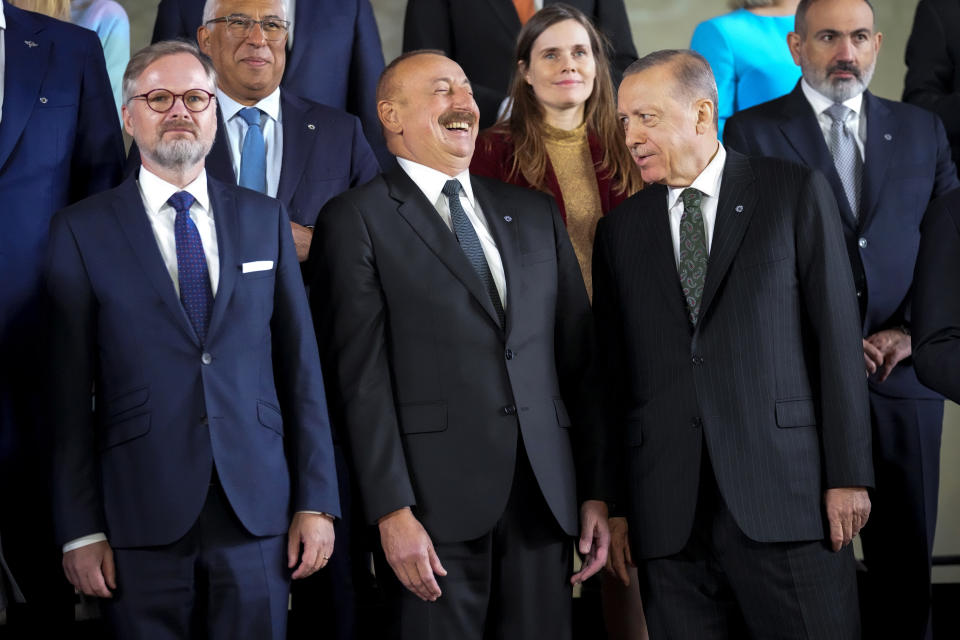 From left, Czech Republic's Prime Minister Petr Fiala, Azerbaijan's President Ilham Aliyev and Turkey's President Recep Tayyip Erdogan pose at a group photo during a meeting of the European Political Community at Prague Castle in Prague, Czech Republic, Thursday, Oct 6, 2022. Leaders from around 44 countries are gathering Thursday to launch a "European Political Community" aimed at boosting security and economic prosperity across the continent, with Russia the one major European power not invited. (AP Photo/Darko Bandic)