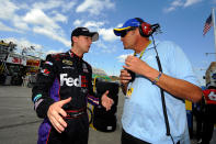 KANSAS CITY, KS - OCTOBER 07: (L-R) Denny Hamlin, driver of the #11 FedEx Freight Toyota, talks with team owner Michael Waltrip during practice for the NASCAR Sprint Cup Series Hollywood Casino 400 at Kansas Speedway on October 7, 2011 in Kansas City, Kansas. (Photo by Jason Smith/Getty Images for NASCAR)