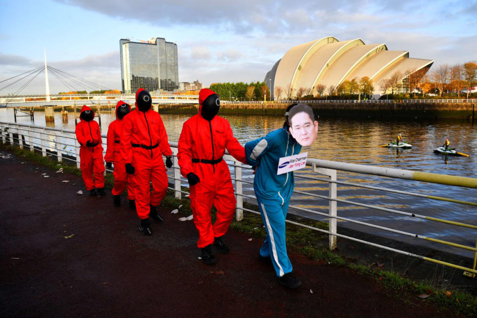 <div class="inline-image__caption"><p>Climate activists dressed as characters inspired by the Netflix series <em>Squid Game</em> ask Samsung to go 100% renewable energy outside the venue for the UN Climate Change Conference (COP26) in Glasgow, Scotland, Nov. 10, 2021.</p></div> <div class="inline-image__credit">Reuters/Dylan Martinez</div>