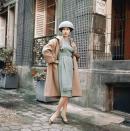 <p>Towards the end of the decade, designer Guy Laroche reinterpreted the wool coat trend (somewhat) by raising the waistline and adding fringe detailing to the front of the dress.<br></p>