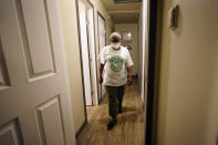 Doris Brown walks down the hallway of her home Friday, July 31, 2020, in Houston. Brown's home flooded during Harvey and she's part of a group called the Harvey Forgotten Survivors Caucus. (AP Photo/David J. Phillip)