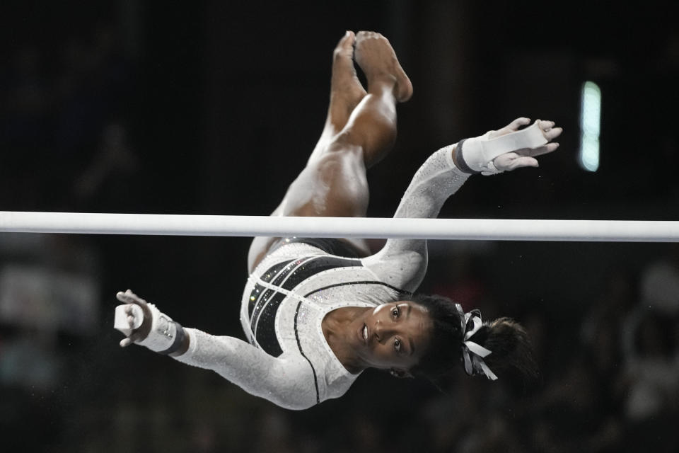 FILE - Simone Biles performs on the uneven bars at the U.S. Classic gymnastics competition on Aug. 5, 2023, in Hoffman Estates, Ill. Biles was named the AP Female Athlete of the Year for a third time on Friday, Dec. 22, 2023, after winning national and world all-around titles in her return to gymnastics following a two-year break after the Tokyo Olympics. (AP Photo/Morry Gash, File)