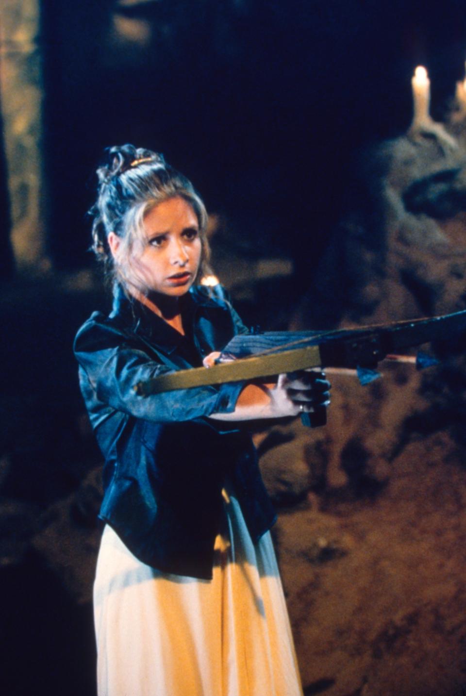 Buffy in her dress and wielding a weapon