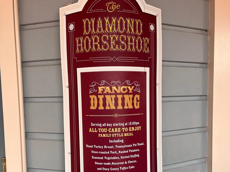 sign outside diamond horseshoe at disney world