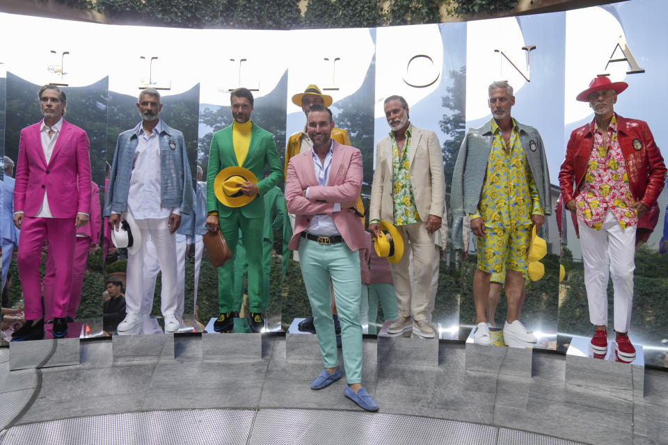 Designer, Philipp Plein, centre stands with models wearing creations as part of the Billionaire men's Spring Summer 2023 collection presented in Milan, Italy, Friday, June 17, 2022. (AP Photo/Luca Bruno)