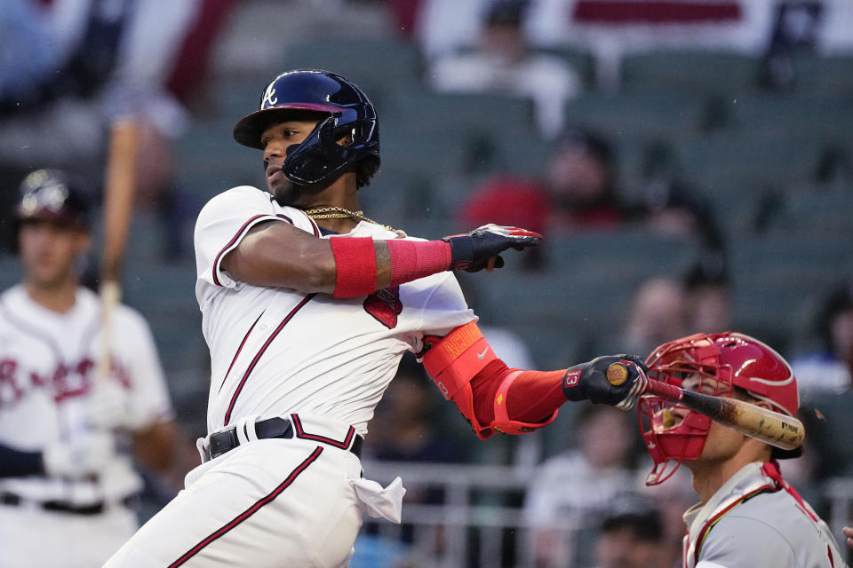 Atlanta Braves' Ronald Acuna Jr. follows through on a two-run single against the Cincinnati Reds during the second inning of a baseball game Wednesday, April 12, 2023, in Atlanta. (AP Photo/John Bazemore)