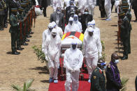 Pallbearers carry the coffin of government minister Dr Ellen Gwaradzimba who died of COVID-19, in Harare, Thursday, Jan. 21, 2021. Zimbabwean President Emmerson Mnangagwa who presided over the burial called the pandemic "evil" and urged people to wear masks, practice social distancing and sanitize, as cases across the country increased amid a fragile health system. (AP Photo/Tsvangirayi Mukwazhi)