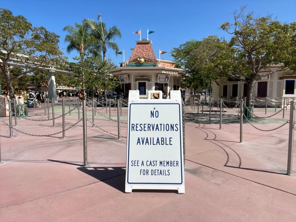 sign that reads "no reservation available" in front of disneyland