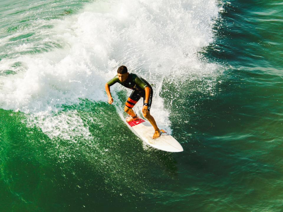 a person surfing a green ocean wave