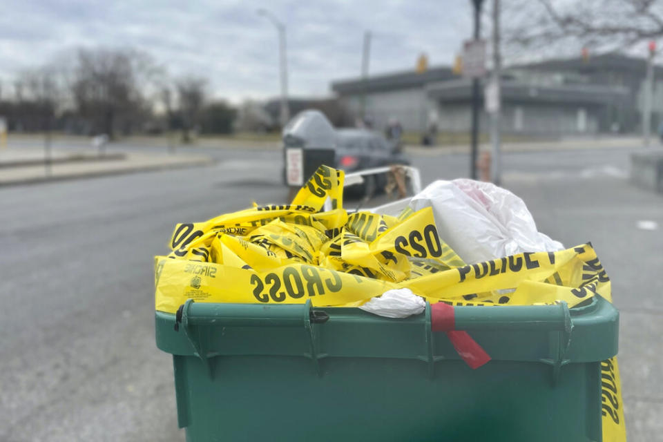 Crime tape spills out of a trash can on Jan. 30, 2023, in Baltimore. 