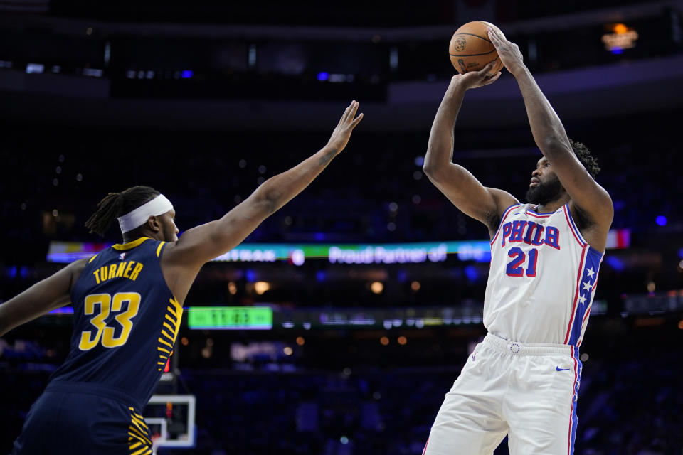 Philadelphia 76ers' Joel Embiid, right, goes up for a shot against Indiana Pacers' Myles Turner during the first half of an NBA basketball game, Sunday, Nov. 12, 2023, in Philadelphia. (AP Photo/Matt Slocum)