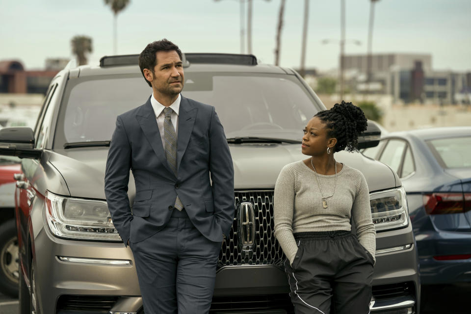 This image released by Netflix shows Manuel Garcia-Rulfo as Mickey Haller, left, and Jazz Raycole as Izzy in a scene from "The Lincoln Lawyer," a series based on the book by Michael Connelly. (Lara Solanki/Netflix via AP)