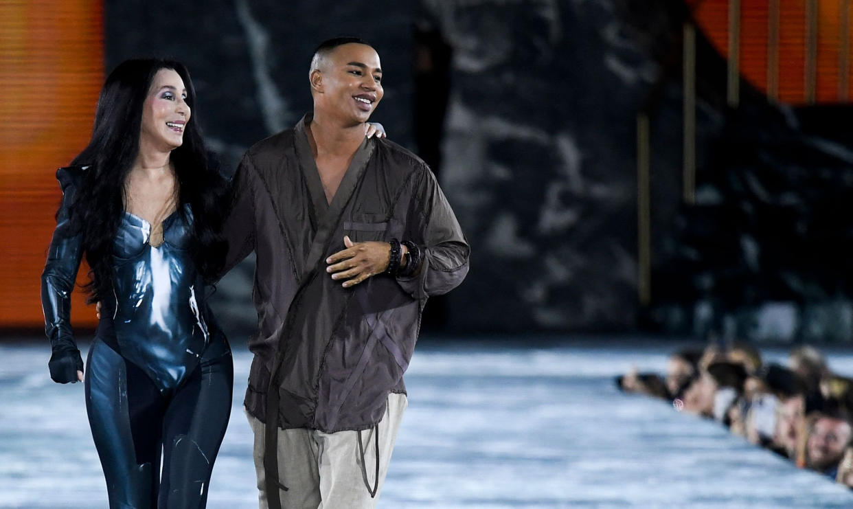 Cher walks next to French fashion designer Olivier Rousteing (Julien De  Rosa / AFP - Getty Images)