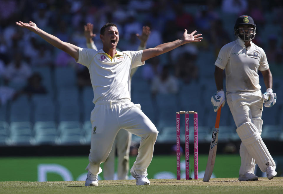 In this Jan. 4, 2019, file photo, Australia's Josh Hazlewood, left, appeals for a LBW decision on India's Rishabh Pant, right, during their cricket test match in Sydney. Cricket Australia is considering an expanded five-test series against India next season and is still planning to host the Twenty20 World Cup later this year, even if it has to be staged in empty stadiums. (AP Photo/Rick Rycroft, File)