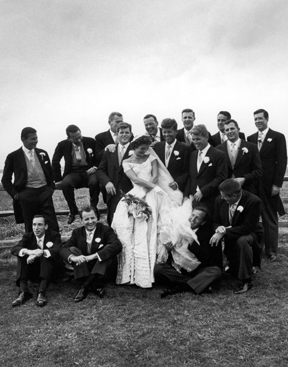 Sen. John F. Kennedy (C), with his bride Jacqueline in their wedding attire. (Photo by Lisa Larsen//Time Life Pictures/Getty Images)