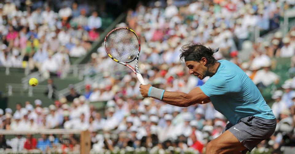 Rafael Nadal of Spain returns the ball to Novak Djokovic of Serbia during their men's singles final match at the French Open Tennis tournament at the Roland Garros stadium in Paris June 8, 2014. REUTERS/Stephane Mahe (FRANCE - Tags: SPORT TENNIS)