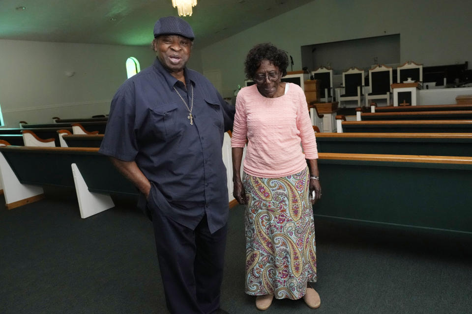 Edward Brown, an original member of the Staple Jr. Singers, left, stands with Johnson Chapel Holiness Church assistant pastor Rev. Letha Morgan, his aunt, and recalls the group of family members playing every Sunday at the Aberdeen, Miss., church, May 20, 2024. (AP Photo/Rogelio V. Solis)