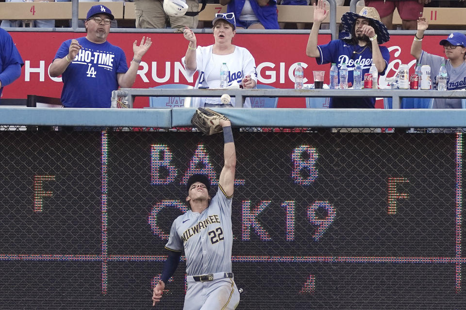 Milwaukee Brewers left fielder Christian Yelich can't get to a ball hit by Los Angeles Dodgers' Miguel Vargas for a solo home run during the eighth inning of a baseball game Saturday, July 6, 2024, in Los Angeles. (AP Photo/Mark J. Terrill)