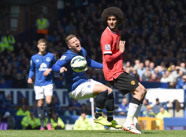 Everton midfielder Ross Barkley (centre) clashes with Manchester United's Marouane Fellaini during the English Premier League match at Goodison Park on April 26, 2015