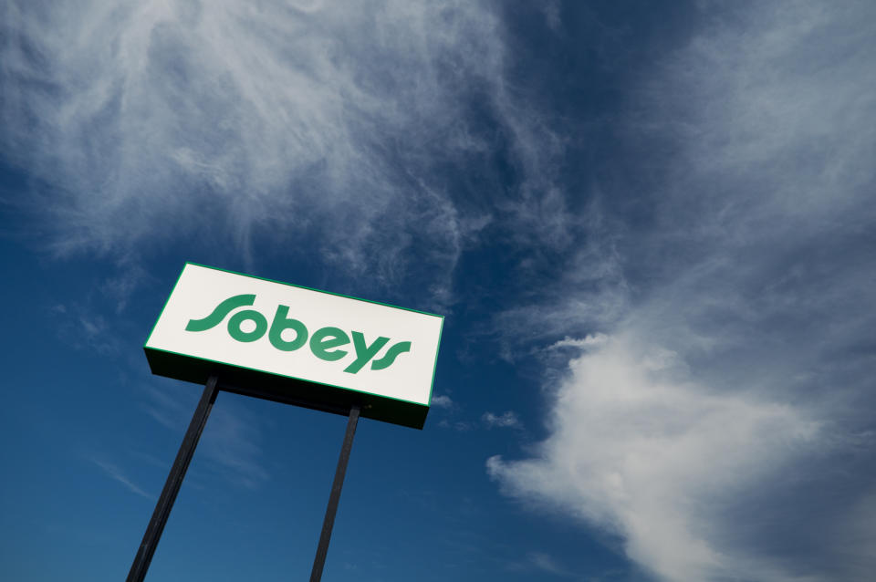Dartmouth, Nova Scotia, Canada - September 30, 2011: Looking up at a tall Sobeys grocery store sign set against blue skies.  Sobeys is the second largest food retailer in Canada, with over 1,300 supermarkets operating under a variety of banners. Headquartered in Stellarton, Nova Scotia, it operates stores in all ten provinces and accumulated sales of more than $14 billion CAD in 2009.