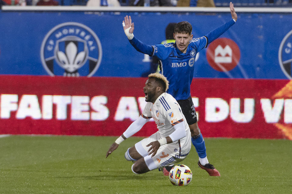 CF Montreal's Joaquin Sosa, right, reacts as the whistle is blown after contact between him and FC Cincinnati's Aaron Boupendza during the second half of an MLS soccer match Saturday, April 13, 2024, in Montreal. (Peter McCabe/The Canadian Press via AP)