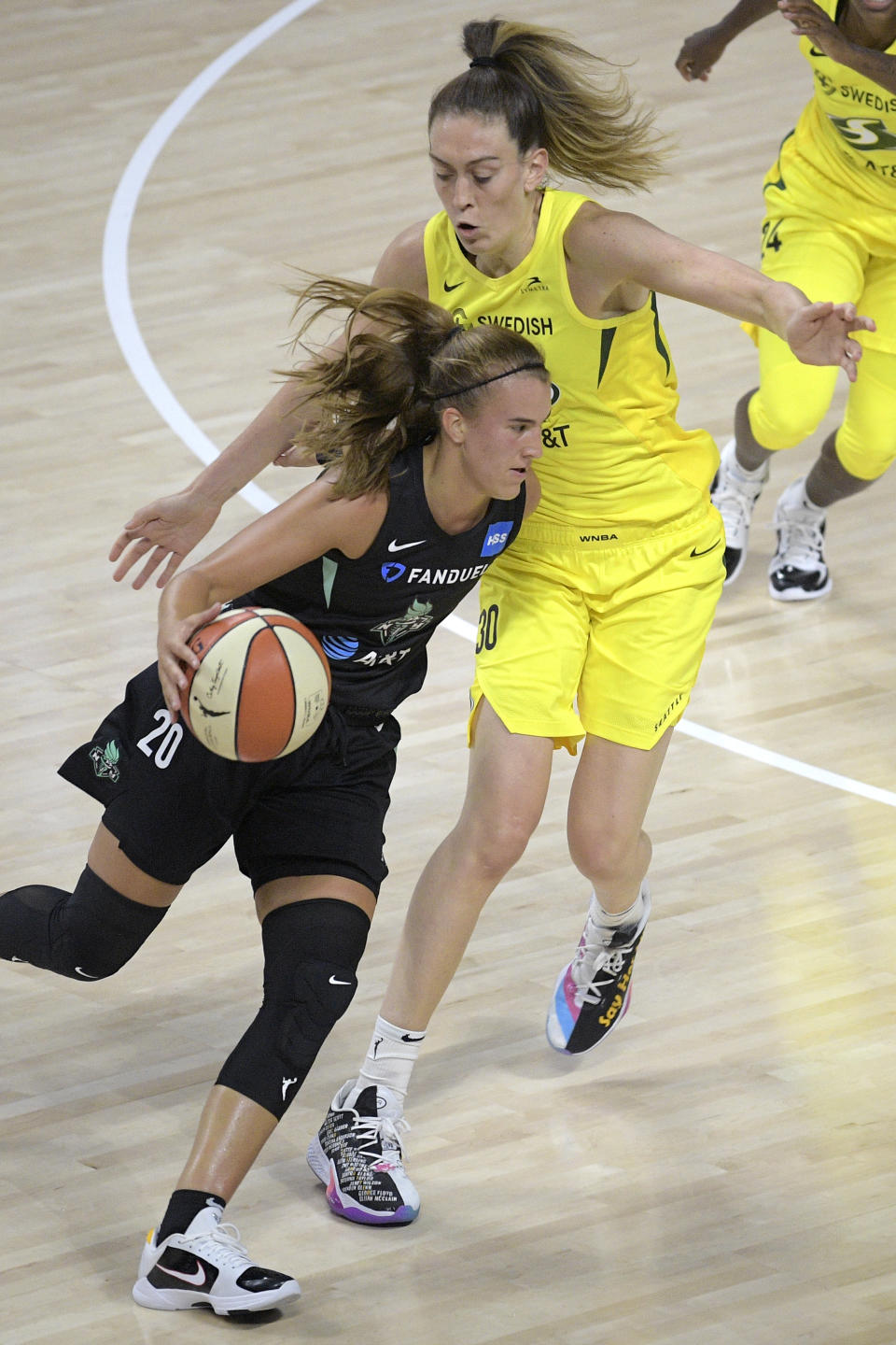 New York Liberty forward Sabrina Ionescu (20) drives past Seattle Storm forward Breanna Stewart (30) during the first half of a WNBA basketball game, Saturday, July 25, 2020, in Ellenton, Fla. (AP Photo/Phelan M. Ebenhack)