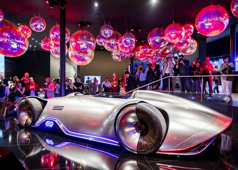 The Mercedes concept car "EQ Silver Arrow" is surrounded by media people at the IAA Auto Show in Frankfurt, Germany, Monday, Sept. 9, 2019. The IAA starts with two media days on Tuesday and Wednesday. (AP Photo/Michael Probst)