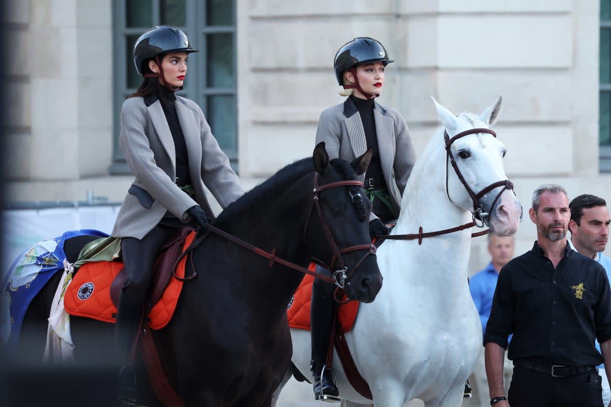 Kendall Jenner and Gigi Hadid ride horses on the runway during Vogue World: Paris at Place Vendome (Getty Images for Vogue)