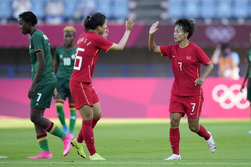 China's Wang Shuang (7) celebrates with her teammates after scoring a second goal against Zambia during a women's soccer match at the 2020 Summer Olympics, Saturday, July 24, 2021, in Saitama, Japan. (AP Photo/Andre Penner)