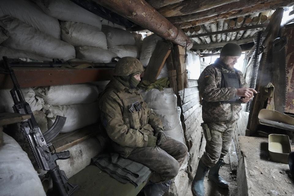 Ukrainian servicemen rest in a shelter on the front line in the Luhansk region, eastern Ukraine, Friday, Jan. 28, 2022. High-stakes diplomacy continued on Friday in a bid to avert a war in Eastern Europe. The urgent efforts come as 100,000 Russian troops are massed near Ukraine's border and the Biden administration worries that Russian President Vladimir Putin will mount some sort of invasion within weeks. (AP Photo/Vadim Ghirda)