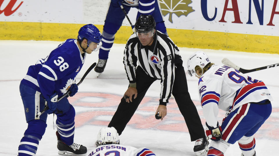 TORONTO, ON - JANUARY 12: Linseman Kevin Hastings #61 drops the puck between Colin Greening #38 of the Toronto Marlies and Alexander Nylander #92 of the Rochester Americans during AHL game action on January 12, 2019 at Coca-Cola Coliseum in Toronto, Ontario, Canada. (Photo by Graig Abel/Getty Images)