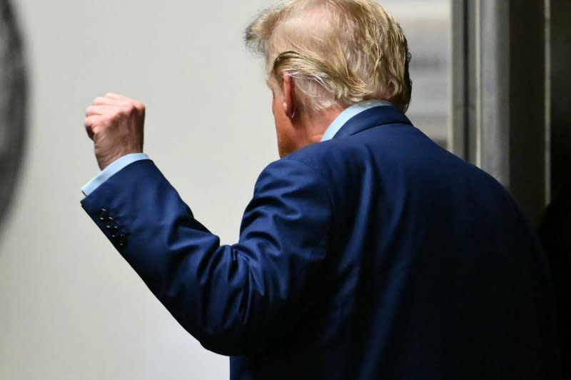 Former President Donald Trump motions with a raised fist as he leaves during a break in his trial at Manhattan criminal court in New York on Thursday. Trump's criminal trial is entering its fourth week on charges he allegedly falsified business records to cover up a sex scandal during the 2016 presidential campaign. Pool Photo by Angela Weiss/UPI