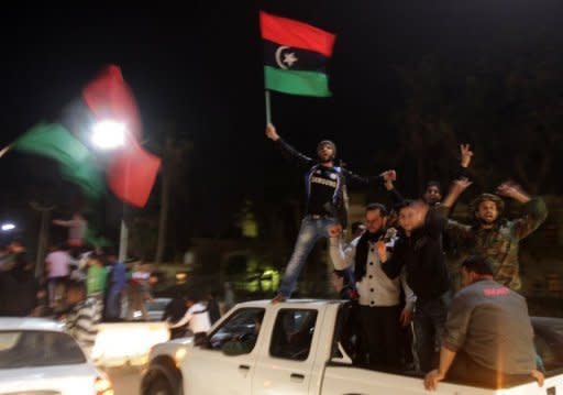 Libyan rebels celebrate in Benghazi last night after the United Nations Security Council voted to impose a no-fly zone over Libya