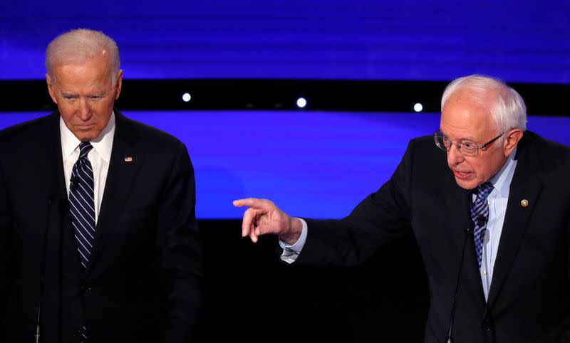 Democratic 2020 U.S. presidential candidate and former Vice President Biden listens as Senator Sanders speaks during the seventh Democratic 2020 presidential debate at Drake University in Des Moines, Iowa, U.S.