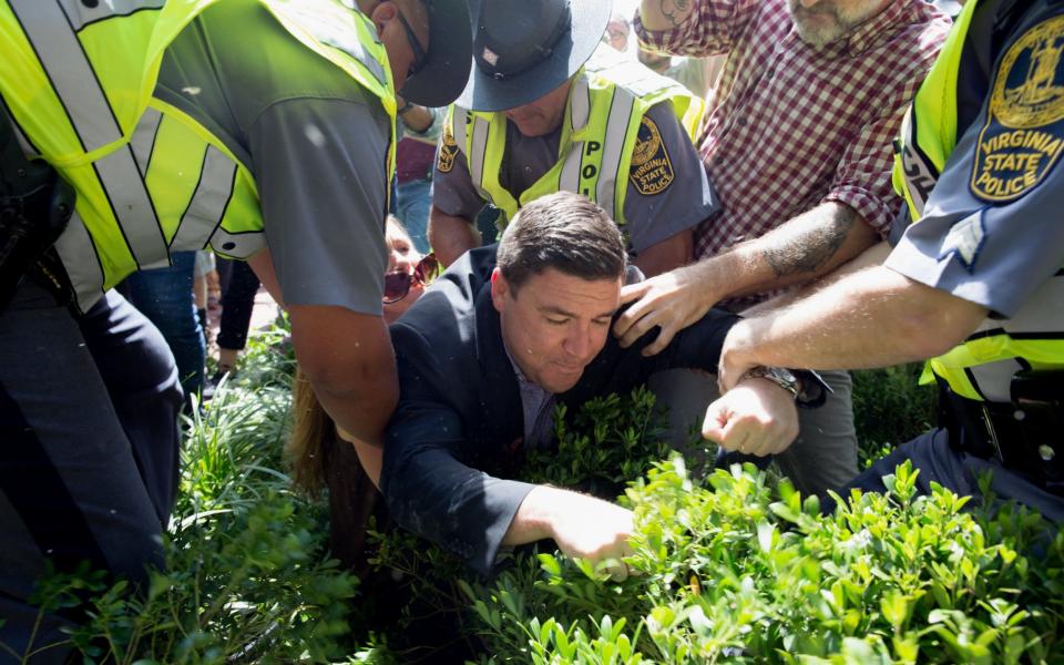 Jason Kessler (R) organizer of the 'Unite the Right' rally is rushed away after a press conference at City Hall in Charlottesville, Virginia, USA, 13 August 2017. According to media reports at least one person was killed and 19 injured after the car hit a crowd of people counter-protesting the 'Unite the Right' rally which was scheduled to take place in Charlottesville on 12 August. At least 15 others were injured in clashes during protests - Tasos Katopodis/EPA