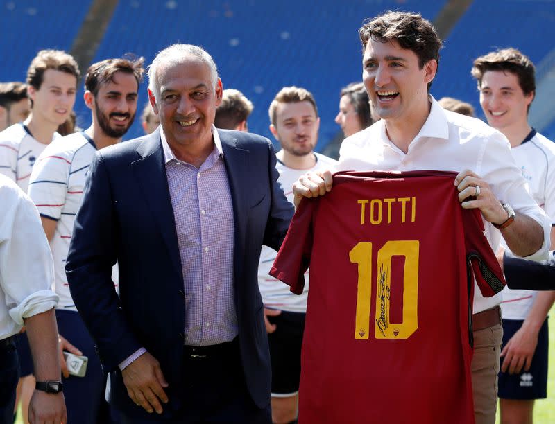 FILE PHOTO: Canada's Prime Minister Justin Trudeau poses with AS Roma's president James Pallotta as he holds an AS Roma's jersey signed by Francesco Totti during the event "Open goal" at the Olympic stadium in Rome