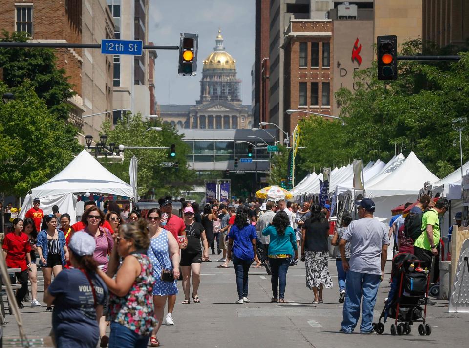 Attendees of the 2018 CelebrAsian festival walk along Locust Avenue in Des Moines on Friday, May 25, 2018.