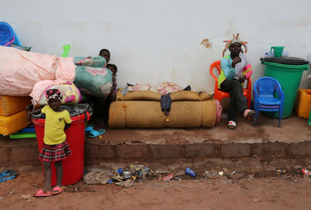 Congolese migrants, who crossed the border with Angola, camp with their belongings outside the General Directorate of Migration (DGM) border agency headquarters at the Kamako border, Kasai province in the Democratic Republic of the Congo, October 13, 2018. REUTERS/Giulia Paravicini