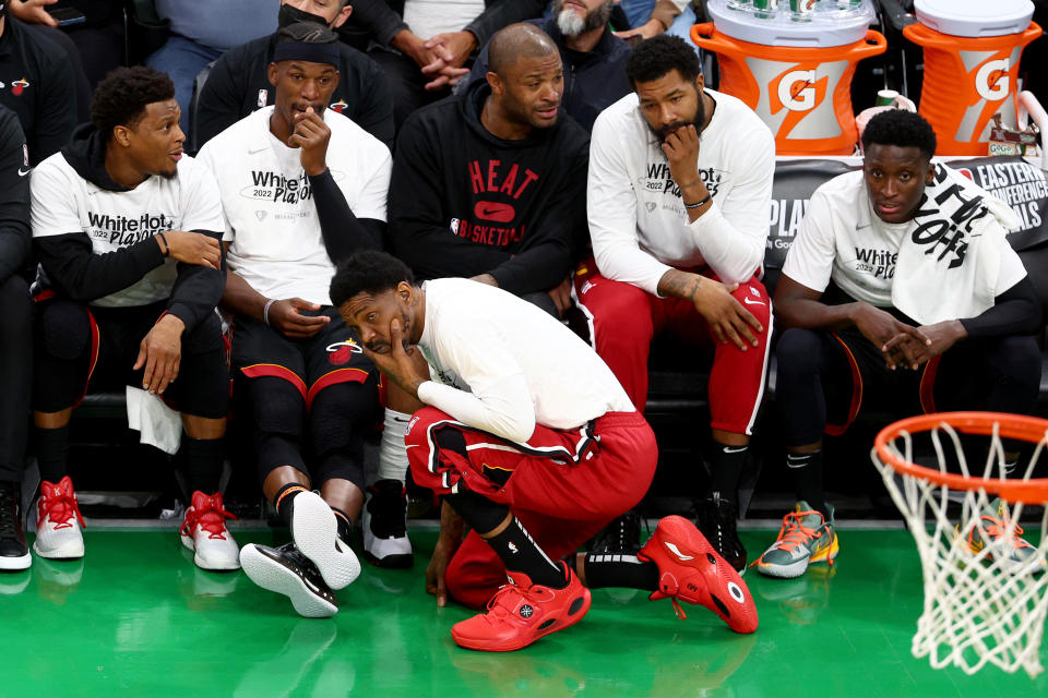 Udonis Haslem crouches in front of his Miami Heat teammates Kyle Lowry, Jimmy Butler, P.J. Tucker, Markieff Morris and Victor Oladipo on the bench during Game 4 of the Eastern Conference finals in Boston on May 23, 2022. (Elsa/Getty Images)